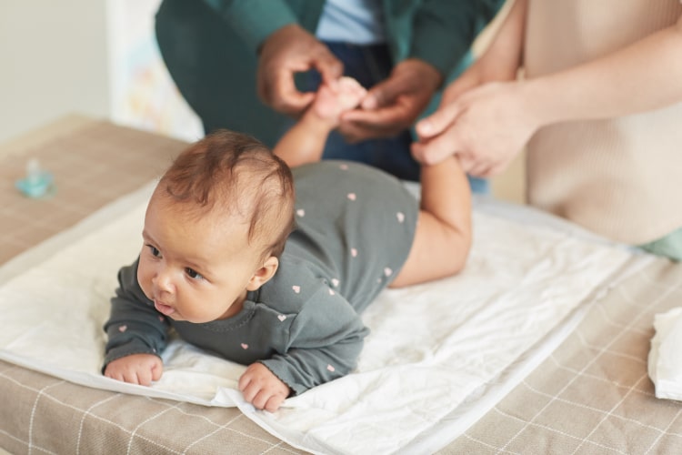 parents-massaging-baby-2023-11-27-04-54-49-utc-min