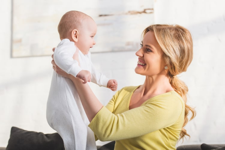 side-view-of-happy-mother-holding-cute-infant-chil-2024-11-18-11-20-06-utc-min